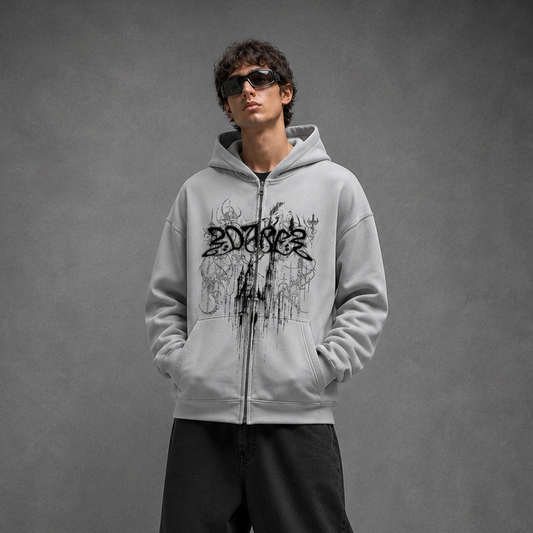 Person wearing a gray hoodie with a logo on a gray background