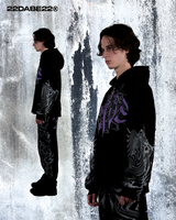 A black and lilac split zip jacket made of high-quality cotton and polyester materials. The jacket features a unique split design with screen print and embroidery appliqué on the front, screen print on the sleeves, a big hood, and a special zipper at the back. The jacket is peached on the inside and comes in an oversized fit with a custom 22 puller. It can be worn with associated joggers for a complete streetwear look.