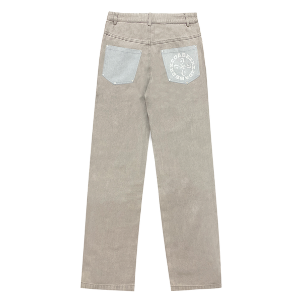 A pair of light grey/blue carpenter denim jeans with black panels at the front and vintage printing effect, featuring custom embossed button, logo rivets, and screen-printed logo at the back-pocket. The jeans have a YKK zipper, waistband with belt loops, and five pockets for storage. Unisex and washed for a vintage look, the jeans offer a comfortable fit and stylish addition to any wardrobe.
