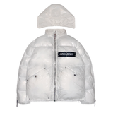 A white puffer jacket from 22DABE22, made of high-quality nylon fabric and cotton down filling, featuring custom logo rivets and buttons, detachable hood, and adjustable drawcords on the bottom hem. The jacket has an oversized fit, with sleeves that can be unzipped for unrestricted movement and ample storage space with one inside pocket and two side pockets. The logo tape at the chest adds a touch of branding.