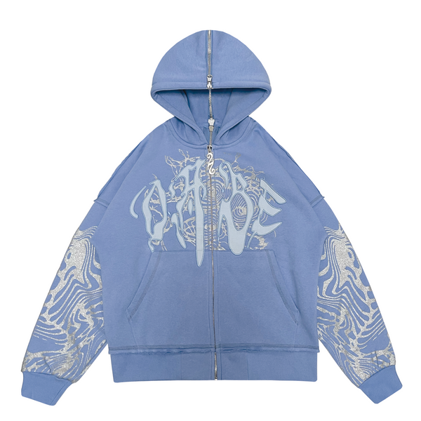 A light blue hooded jacket with a split zipper at the back. The jacket features a glitter screen print and embroidery appliqué on the front, with additional glitter screen print detailing on the sleeves. The jacket has an oversized fit and a peached interior lining for a cozy feel. The custom 22 puller adds a unique touch to the zipper.