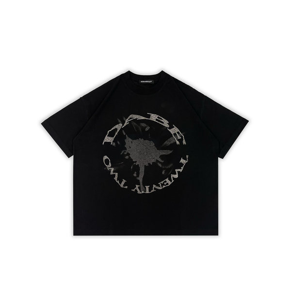 A black oversized t-shirt with a glitter screenprint on the front, made from 100% cotton with a distressed finish. The shirt is unisex and has a high-quality screenprint that stays vibrant after washing. The shirt is versatile and can be paired with jeans, joggers, or shorts.