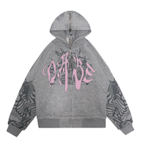 Grey/Pink Split Zip Jacket from 22DABE22: A long sleeve hooded zip jacket with a unique split design in grey and pink. Front features screen print and embroidery appliqué, with screen print on sleeves. Special feature zipper at the back allows for reversible wear. Made from 80% cotton and 20% polyester, weighing 500 GSM. Soft peached finish on the inside, with a distressed finish for edginess.