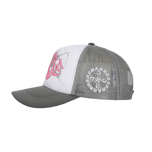 The Cap Broken Glass Grey/Pink by 22DABE22. A black six-panel cap with a lilac broken glass design embroidered on the front and 22DABE22 logo on the side. Adjustable strap at the back for a customized fit, pre-curved visor to shield from sun and rain, and breathable eyelets on top to keep the head cool and dry. Perfect accessory to elevate your streetwear game.