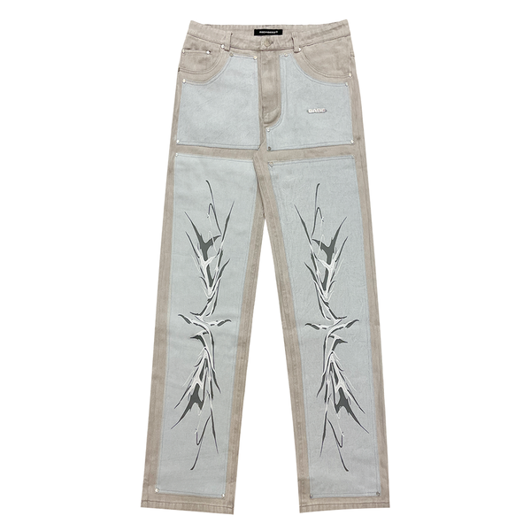 A pair of light grey/blue carpenter denim jeans with black panels at the front and vintage printing effect, featuring custom embossed button, logo rivets, and screen-printed logo at the back-pocket. The jeans have a YKK zipper, waistband with belt loops, and five pockets for storage. Unisex and washed for a vintage look, the jeans offer a comfortable fit and stylish addition to any wardrobe.