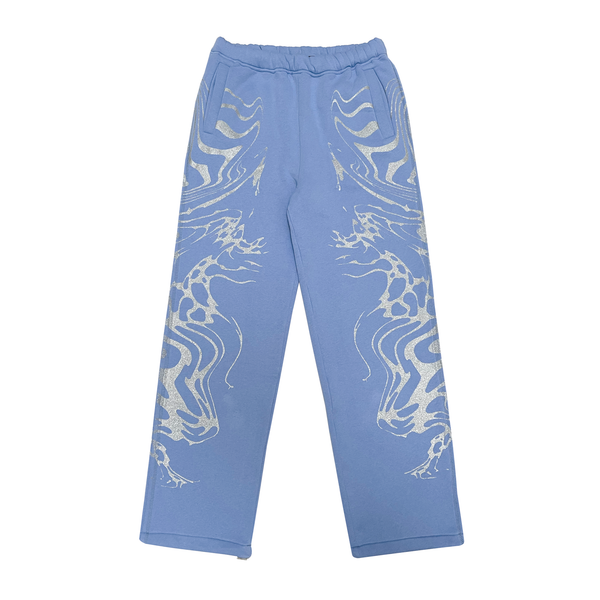 A pair of light blue joggers with glitter screen print on both sides, an embroidery appliqué at the back pockets, and a distressed finish. Made of 80% Cotton and 20% Polyester blend with a peached interior for ultimate comfort and durability. Oversized fit and perfect for streetwear collection.
