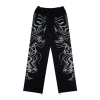 A pair of black and lilac joggers from 22DABE22 with a distressed finish, adjustable waist and leg openings, and oversized unisex fit. Screen prints on both sides and embroidery appliqué at the back pockets add a unique touch to the high-quality blend of 80% cotton and 20% polyester fabric. Pair it with the matching zip jacket for a complete streetwear set.