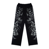 A pair of black and lilac joggers from 22DABE22 with a distressed finish, adjustable waist and leg openings, and oversized unisex fit. Screen prints on both sides and embroidery appliqué at the back pockets add a unique touch to the high-quality blend of 80% cotton and 20% polyester fabric. Pair it with the matching zip jacket for a complete streetwear set.