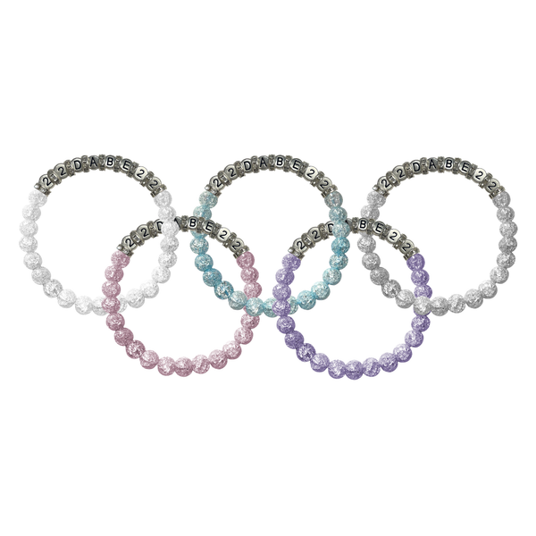 A set of five Glass Pearl Bracelets on an elastic cord, crafted from high-quality materials, with a lustrous and elegant shine. The bracelets are versatile, perfect for dressing up or down, and can be worn individually or layered with other bracelets. Comes in a bundle with an Olympic theme. Caution: May attract attention.